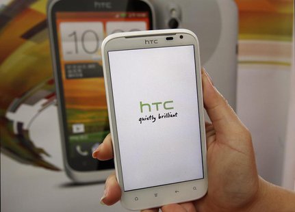 A salesperson shows an HTC Sensation XL smartphone in a mobile phone shop in Taipei April 8, 2013. REUTERS/Pichi Chuang A salesperson shows an HTC Sensation XL smartphone in a mobile phone shop in Taipei April 8, 2013. REUTERS/Pichi Chuang