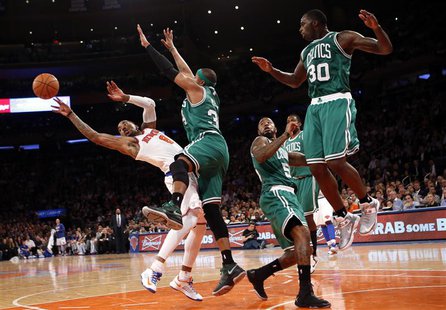 New York Knicks' J.R. Smith (L) tries to pass as he is defended by Boston Celtics' Paul Pierce(2nd from L) in the fourth quarter in Game 5 o New York Knicks' J.R. Smith (L) tries to pass as he is defended by Boston Celtics' Paul Pierce(2nd from L) in the fourth quarter in Game 5 o