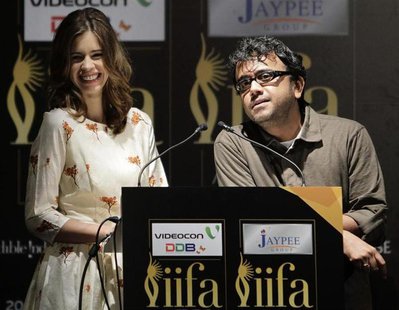 Bollywood actress Kalki Koechlin smiles as director Dibakar Banerjee (R) speaks during the opening news conference of the 13th International Bollywood actress Kalki Koechlin smiles as director Dibakar Banerjee (R) speaks during the opening news conference of the 13th International