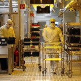 Employees are pictured inside a clean room of German semiconductor manufacturer Infineon in Regensburg February 12, 2013. REUTERS/Michael Da Employees are pictured inside a clean room of German semiconductor manufacturer Infineon in Regensburg February 12, 2013. REUTERS/Michael Da