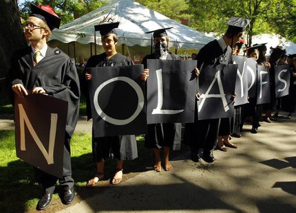 Students hold letters spelling out "No layoffs" during the 361st Commencement Exercises at Harvard University in Cambridge, Massachusetts Ma Students hold letters spelling out "No layoffs" during the 361st Commencement Exercises at Harvard University in Cambridge, Massachusetts Ma