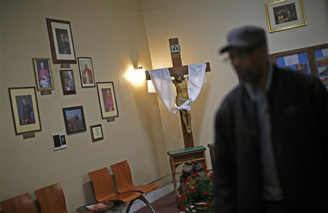 A worker walks through the reception area at Leo Catholic High School in Chicago, Illinois February 14, 2013. REUTERS/Jim Young A worker walks through the reception area at Leo Catholic High School in Chicago, Illinois February 14, 2013. REUTERS/Jim Young