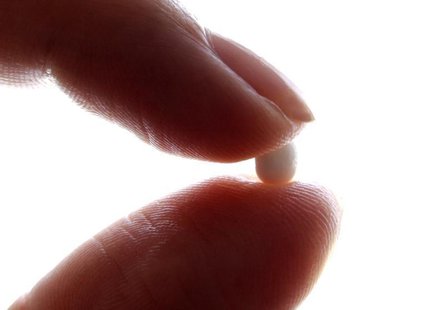 An illustration picture shows a woman holding a birth control pill at her home in Nice January 3, 2013. REUTERS/Eric Gaillard An illustration picture shows a woman holding a birth control pill at her home in Nice January 3, 2013. REUTERS/Eric Gaillard