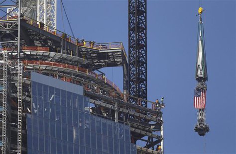 The final section of the spire that will top off One World Trade Center is raised past iron workers to the top of the building in New York, The final section of the spire that will top off One World Trade Center is raised past iron workers to the top of the building in New York,