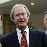 Newly elected Rhode Island Governor Lincoln Chafee (C) speaks to the media between other Governors-elect Dan Malloy of Connecticut (L) and P