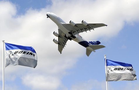 Boeing flags flutter as an Airbus A380, the world's largest jetliner, takes part in a flying display during the 49th Paris Air Show at the L Boeing flags flutter as an Airbus A380, the world's largest jetliner, takes part in a flying display during the 49th Paris Air Show at the L
