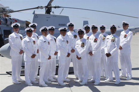 Members of first U.S. Navy helicopter squadron to include manned and unmanned aircraft pose with one of their aircraft after a ceremony at N Members of first U.S. Navy helicopter squadron to include manned and unmanned aircraft pose with one of their aircraft after a ceremony at N