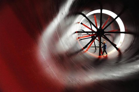 A worker walks past newly-made cement mill barrels at a heavy equipment manufacturing factory in Luoyang, Henan province May 1, 2013. REUTER A worker walks past newly-made cement mill barrels at a heavy equipment manufacturing factory in Luoyang, Henan province May 1, 2013. REUTER
