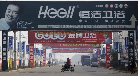 A motorist drives under advertisement boards at the business area of Ruzhou county, China's central Henan province, December 18, 2012. REUTE A motorist drives under advertisement boards at the business area of Ruzhou county, China's central Henan province, December 18, 2012. REUTE