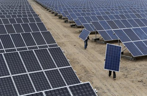 Employees carry solar panels at a solar power plant in Aksu, Xinjiang Uyghur Autonomous Region May 18, 2012. REUTERS/Stringer Employees carry solar panels at a solar power plant in Aksu, Xinjiang Uyghur Autonomous Region May 18, 2012. REUTERS/Stringer