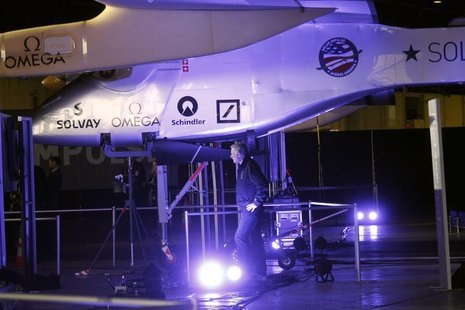 A man walks below the Solar Impulse aircraft at Moffett Field in Mountain View, California March 28, 2013. REUTERS/Robert Galbraith A man walks below the Solar Impulse aircraft at Moffett Field in Mountain View, California March 28, 2013. REUTERS/Robert Galbraith