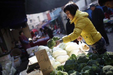 A woman holds up cauliflowers at a stall inside a market in Shanghai December 9, 2011. REUTERS/Aly Song A woman holds up cauliflowers at a stall inside a market in Shanghai December 9, 2011. REUTERS/Aly Song