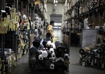 A worker wheels rolls of cloth through the Karen Kane clothing company in Los Angeles, California June 30, 2011. REUTERS/Lucy Nicholson A worker wheels rolls of cloth through the Karen Kane clothing company in Los Angeles, California June 30, 2011. REUTERS/Lucy Nicholson