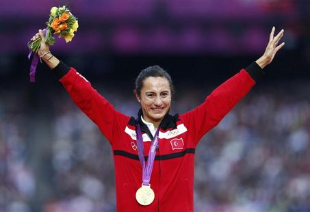 Gold medallist Turkey's Asli Cakir Alptekin smiles during the women's 1500 victory ceremony at the London 2012 Olympic Games at the Olympic Gold medallist Turkey's Asli Cakir Alptekin smiles during the women's 1500 victory ceremony at the London 2012 Olympic Games at the Olympic
