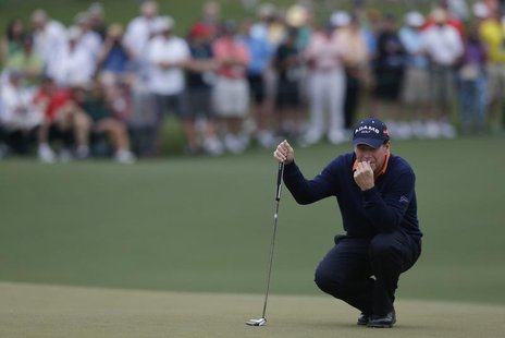 Former champion Tom Watson of the U.S. lines up a putt on the second green during first round play in the 2013 Masters golf tournament at th Former champion Tom Watson of the U.S. lines up a putt on the second green during first round play in the 2013 Masters golf tournament at th