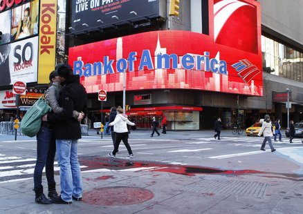 A couple embraces in front of a Bank of America sign on a building in Times Square in New York March 8, 2011. REUTERS/Lucas Jackson A couple embraces in front of a Bank of America sign on a building in Times Square in New York March 8, 2011. REUTERS/Lucas Jackson