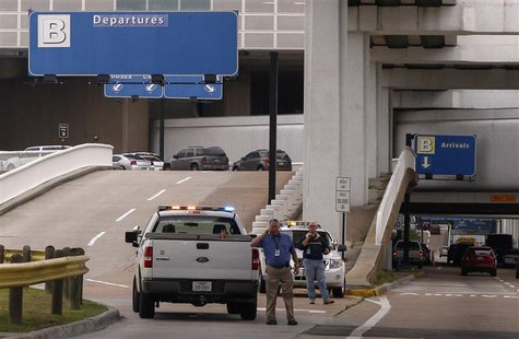 Airport security officials block vehicle access to Terminal B after a gunman opened fire at the terminal in George Bush Intercontinental Air Airport security officials block vehicle access to Terminal B after a gunman opened fire at the terminal in George Bush Intercontinental Air