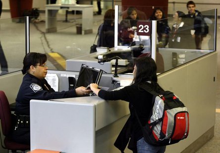 A foreign airline passenger is greeted by a Customs and Border Protection Officer at Hartsfield-Jackson International Airport in Atlanta, Ge A foreign airline passenger is greeted by a Customs and Border Protection Officer at Hartsfield-Jackson International Airport in Atlanta, Ge