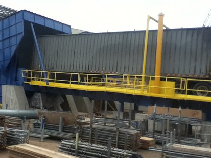 This device lifts an entire semi truck full of wood waste to empty it for use as biomass fuel. Conveyor belts move the fuel to the nearby storage building. This device lifts an entire semi truck full of wood waste to empty it for use as biomass fuel. Conveyor belts move the fuel to the nearby storage building.