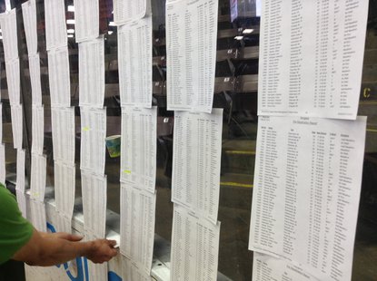 Runners look up race number at 2013 Kalamazoo Marathon Expo Runners look up race number at 2013 Kalamazoo Marathon Expo