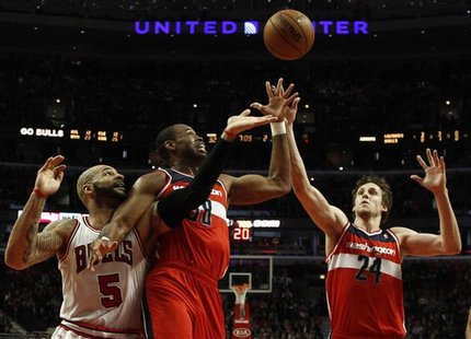 Washington Wizards' Jason Collins (C) and Wizards' Jan Vesely (R) battle for a rebound against Chicago Bulls' Carlos Boozer during the first Washington Wizards' Jason Collins (C) and Wizards' Jan Vesely (R) battle for a rebound against Chicago Bulls' Carlos Boozer during the first