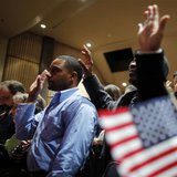 Over 90 immigrants representing over 40 countries take the oath of citizenship during a naturalization ceremony to become new citizens of th