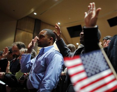 Over 90 immigrants representing over 40 countries take the oath of citizenship during a naturalization ceremony to become new citizens of th Over 90 immigrants representing over 40 countries take the oath of citizenship during a naturalization ceremony to become new citizens of th