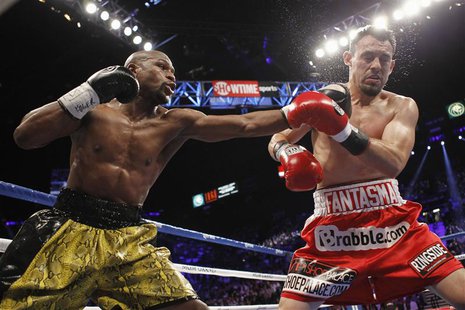 WBC welterweight champion Floyd Mayweather Jr. (L) of the U.S. connects a punch on Robert Guerrero, also of the U.S., during their title fig WBC welterweight champion Floyd Mayweather Jr. (L) of the U.S. connects a punch on Robert Guerrero, also of the U.S., during their title fig