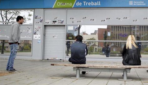 People wait for an employment office to open in Badalona, near Barcelona, April 25, 2013. The stickers on the wall read, "Unemployment". REU People wait for an employment office to open in Badalona, near Barcelona, April 25, 2013. The stickers on the wall read, "Unemployment". REU