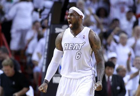 Miami Heat forward LeBron James reacts after dunking the ball in the fourth quarter as the Heat defeated the Milwaukee Bucks in their NBA fi Miami Heat forward LeBron James reacts after dunking the ball in the fourth quarter as the Heat defeated the Milwaukee Bucks in their NBA fi