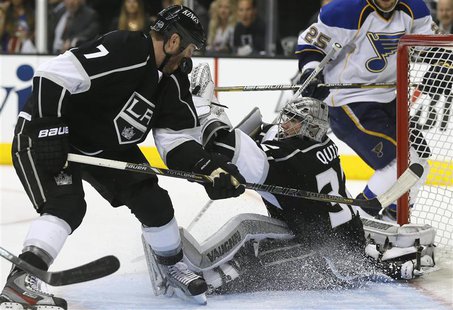 Los Angeles Kings' goaltender Jonathan Quick (R) makes a save as the Kings Rob Scuderi defends against the St. Louis Blues during Game 3 of Los Angeles Kings' goaltender Jonathan Quick (R) makes a save as the Kings Rob Scuderi defends against the St. Louis Blues during Game 3 of