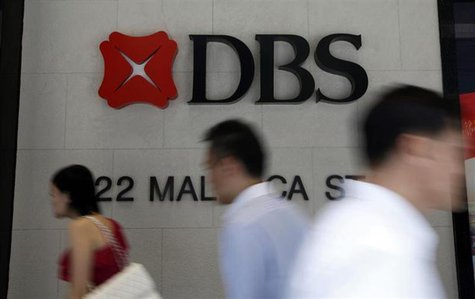 Office workers pass a logo of Development Bank of Singapore (DBS) in the central business district in Singapore April 30, 2013. REUTERS/Edga Office workers pass a logo of Development Bank of Singapore (DBS) in the central business district in Singapore April 30, 2013. REUTERS/Edga