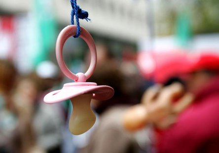 A baby pacifier hangs from an umbrella as part of the props used by union workers in a non-profit sector march in Brussels December 2, 2005. A baby pacifier hangs from an umbrella as part of the props used by union workers in a non-profit sector march in Brussels December 2, 2005.