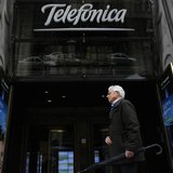 A man walks past Telefonica's building in central Madrid March 26, 2013. REUTERS/Juan Medina A man walks past Telefonica's building in central Madrid March 26, 2013. REUTERS/Juan Medina
