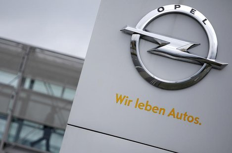 A sign depicting the Opel logo is pictured in front of the Opel Adam AG headquarters as a person passes by in Ruesselheim April 10, 2013. Th A sign depicting the Opel logo is pictured in front of the Opel Adam AG headquarters as a person passes by in Ruesselheim April 10, 2013. Th