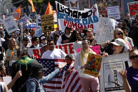 Demonstrators carry signs during an immigration rally on May Day in the Mission District in San Francisco, California May 1, 2013. REUTERS/R Demonstrators carry signs during an immigration rally on May Day in the Mission District in San Francisco, California May 1, 2013. REUTERS/R