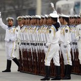 Members of the People's Liberation Army's navy guard of honour prepare to use a string to ensure that soldiers stand in a straight line befo Members of the People's Liberation Army's navy guard of honour prepare to use a string to ensure that soldiers stand in a straight line befo