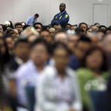 A security guard stands guard near immigrants during a naturalization ceremony in Los Angeles April 16, 2013. REUTERS/Lucy Nicholson A security guard stands guard near immigrants during a naturalization ceremony in Los Angeles April 16, 2013. REUTERS/Lucy Nicholson