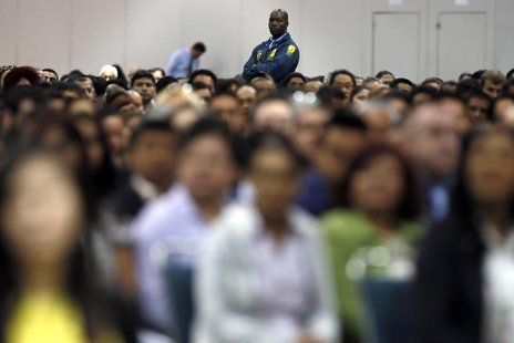 A security guard stands guard near immigrants during a naturalization ceremony in Los Angeles April 16, 2013. REUTERS/Lucy Nicholson A security guard stands guard near immigrants during a naturalization ceremony in Los Angeles April 16, 2013. REUTERS/Lucy Nicholson
