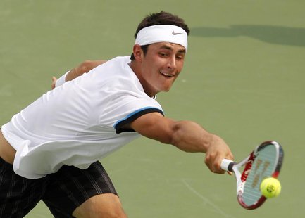 Bernard Tomic of Australia hits a return shot to Roger Federer of Switzerland during their third round match in the 2012 Cincinnati Open ten Bernard Tomic of Australia hits a return shot to Roger Federer of Switzerland during their third round match in the 2012 Cincinnati Open ten
