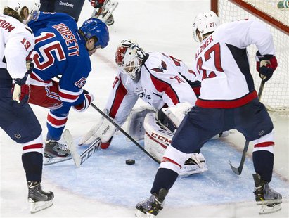 Washington Capitals goalie Braden Holtby (70) stops a shot by New York Rangers right wing Derek Dorsett (15) in the third period of Game 3 o Washington Capitals goalie Braden Holtby (70) stops a shot by New York Rangers right wing Derek Dorsett (15) in the third period of Game 3 o