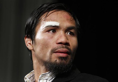 Manny Pacquiao of the Philippines attends a post-fight news conference following his majority decision victory over Juan Manuel Marquez of M Manny Pacquiao of the Philippines attends a post-fight news conference following his majority decision victory over Juan Manuel Marquez of M