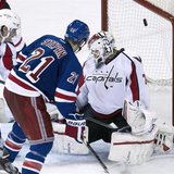 New York Rangers center Derek Stepan (21) scores past Washington Capitals goalie Braden Holtby in the third period of Game 3 of their NHL St