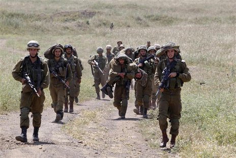 Israeli soldiers walk together during training close to the ceasefire line between Israel and Syria on the Israeli occupied Golan Heights Ma Israeli soldiers walk together during training close to the ceasefire line between Israel and Syria on the Israeli occupied Golan Heights Ma