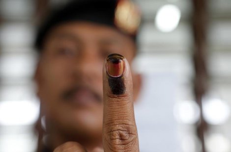 A Malaysian voter shows his finger marked with ink after casting his ballot during the early voting for the general elections in Kuala Lumpu A Malaysian voter shows his finger marked with ink after casting his ballot during the early voting for the general elections in Kuala Lumpu