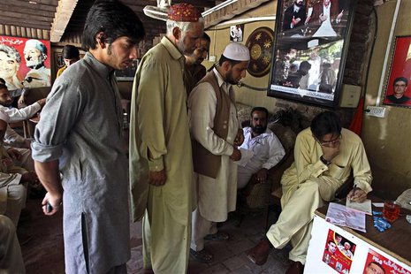 Haroon Bilour (R), an Awami National Party (ANP) candidate for the upcoming elections, meets with constituents seeking help for problems at Haroon Bilour (R), an Awami National Party (ANP) candidate for the upcoming elections, meets with constituents seeking help for problems at