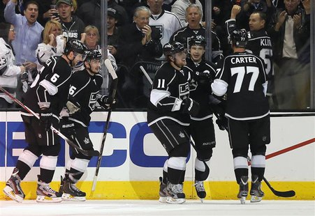 Los Angeles Kings Anze Kopitar (3rd R) celebrates with Dustin Brown (2nd R) and Jeff Carter after scoring against the St. Louis Blues during Los Angeles Kings Anze Kopitar (3rd R) celebrates with Dustin Brown (2nd R) and Jeff Carter after scoring against the St. Louis Blues during
