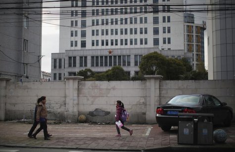 Locals walk in front of 'Unit 61398', a secretive Chinese military unit, in the outskirts of Shanghai February 19, 2013. REUTERS/Carlos Barr Locals walk in front of 'Unit 61398', a secretive Chinese military unit, in the outskirts of Shanghai February 19, 2013. REUTERS/Carlos Barr