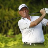 Colin Montgomerie of Scotland tees off on the 12th hole during the first round of the Barclays Singapore Open golf tournament in Sentosa Nov