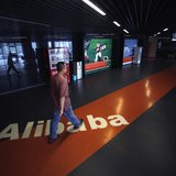An employee walks past a logo of Alibaba (China) Technology Co. Ltd during a media tour organised by government officials at its headquarter An employee walks past a logo of Alibaba (China) Technology Co. Ltd during a media tour organised by government officials at its headquarter